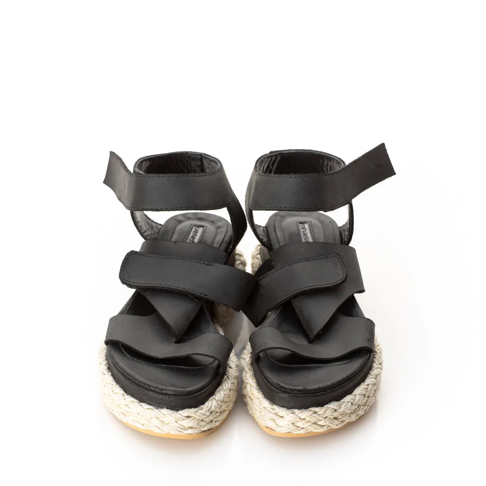Folded black leather sandals
